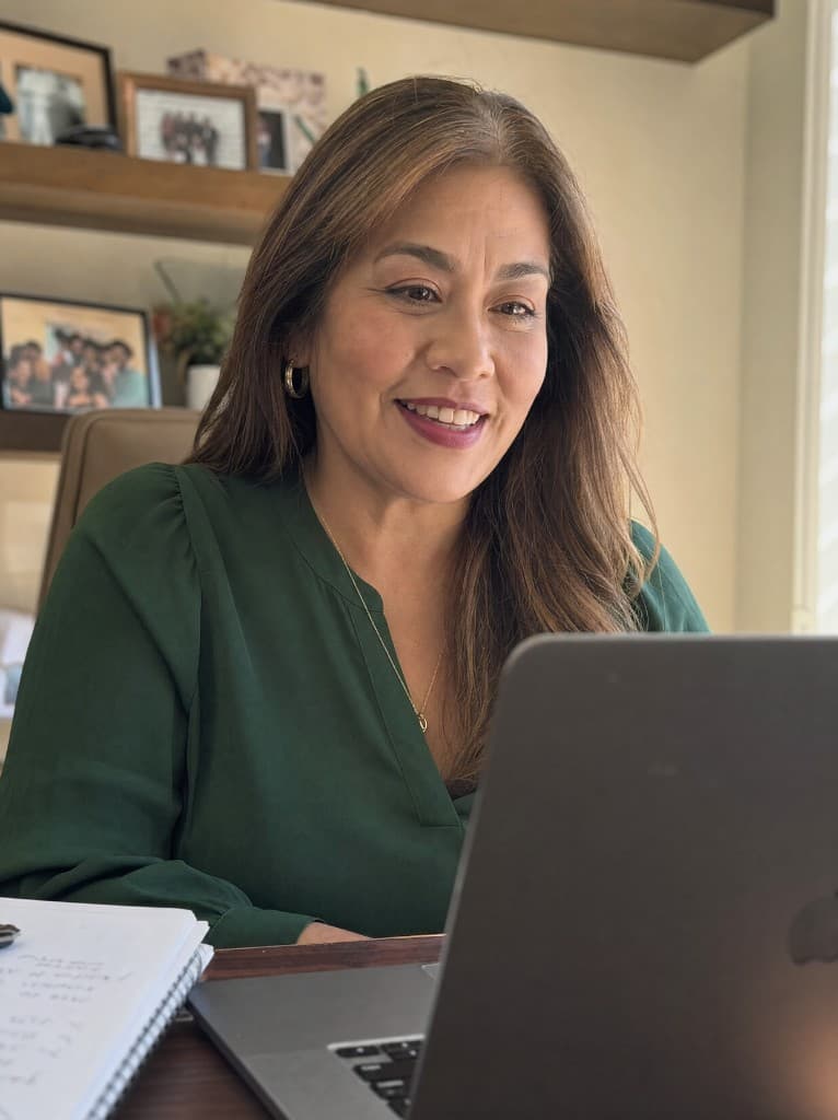 IUL producer reviewing booked appointments at her desk